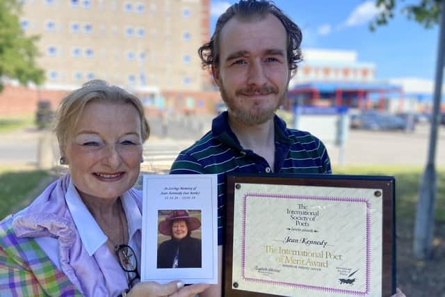 The late Jean Kennedy's daughter Michelle Plant (60) with son Robert Blackthorne (29) holding a copy of the book and Jean's International Poet of Merit award.