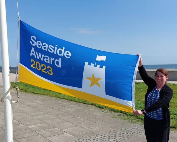 Debbie Kershaw, Hartlepool Borough Council’s quality and safety officer, raises the Seaside Award flag at Seaton Carew.