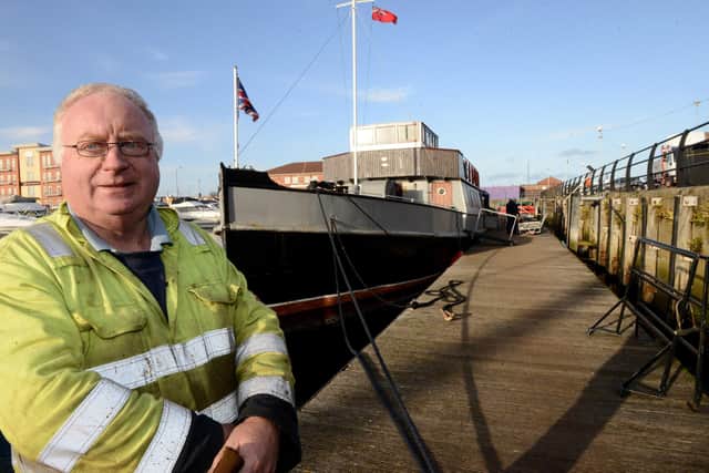 Graham Beesley alongside the MV Coronia which has been restored at Hartlepool Marina. Picture by FRANK REID