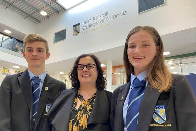 Alison Taylor of Zoe's Place with students George Holmes and Casey Walton after being presented with a cheque for £5,500 by High Tunstall College of Science. Picture by FRANK REID