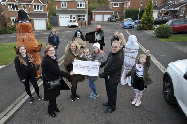 Pam and Bill Shurmer are presented with a cheque for £3606.75 for the DS43 Community Defibrilators fund by Nuthatch Close residents Debbie McGibbon, Joanna Brobble and her daughter Meghan.