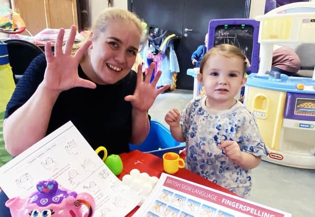 Leanne Eagle teaching sign language to Aliya Grace Brown aged two at the Place In The Park in Ward Jackson Park, Hartlepool. Picture by FRANK REID