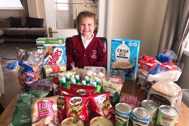 Eva Armes of West View Primary School is pictured with a typical food hamper