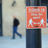 A sign advising people to stay two metres apart on a lamppost in the centre of Bradford, West Yorkshire, one of the areas where new measures have been implemented to prevent the spread of coronavirus. Picture: PA.