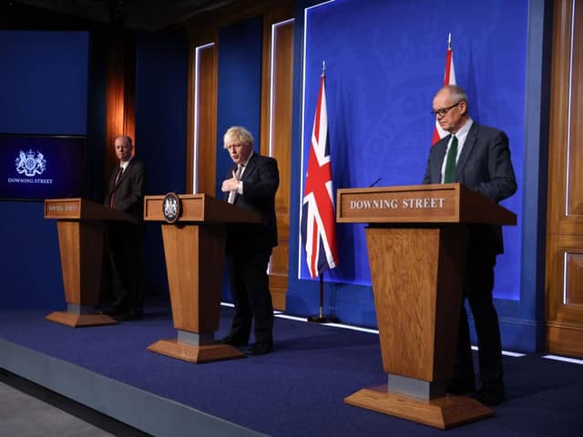 Prime Minister Boris Johnson stands between British Chief Medical Officer for England Chris Whitty, left, and British Chief Scientific Adviser Patrick Vallance during a press conference on Saturday, November 27. Picture: Hollie Adams - WPA Pool/Getty Images.