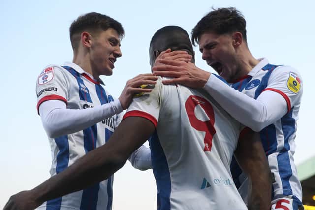 Hartlepool United's Josh Umerah celebrates with Edon Pruti and Joe Grey after scoring their first goal during the League Two match with Rochdale. (Credit: Mark Fletcher | MI News)