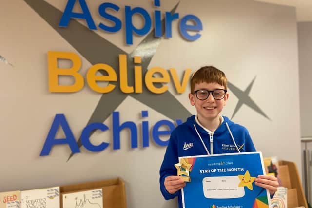 Nine-year-old Rory Betts holding his certificate for Star of the Month from Reading Solutions UK.