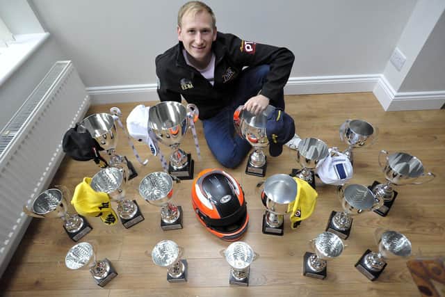 Dominic Wheatley, winner of the 2021 Mini Challenge, with trophies he has won over the years.