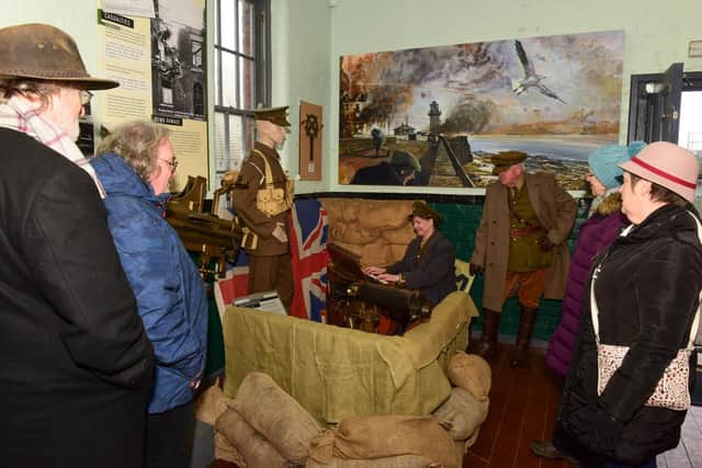 Bev Palin of re-enactment group Time Bandits, playing the only surviving World War One trench organ, at the Heugh Battery museum on Saturday.