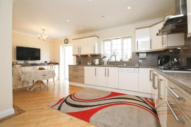 The spacious kitchen is fitted with a range of appliances.