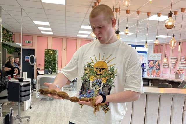 Harvey Maddison, 17, has had his hair shaved off to raise money for the Little Princess Trust following a recent cancer diagnosis. Here he is pictured holding 22 inches of his hair that he had been growing since lockdown.