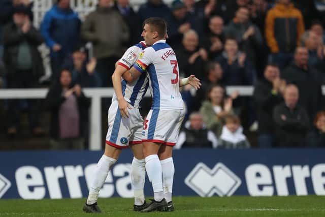 Hartlepool United's David Ferguson congratulates Alex Lacey after he levelled the score at 1-1 against Grimsby Town. (Credit: Mark Fletcher | MI News)