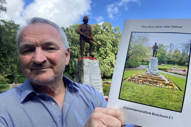 Steve Close in Ward Jackson Park, Hartlepool, with the new Boer War Statue behind him and a copy of the commemorative brochure he has published. Picture by FRANK REID.