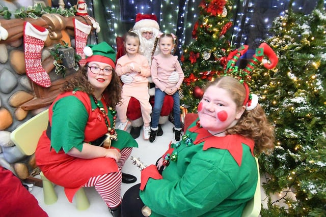 Twins Summer and Lola Thompson (6) with Santa and his elves at Middleton Grange Shopping Centre. Picture by FRANK REID
