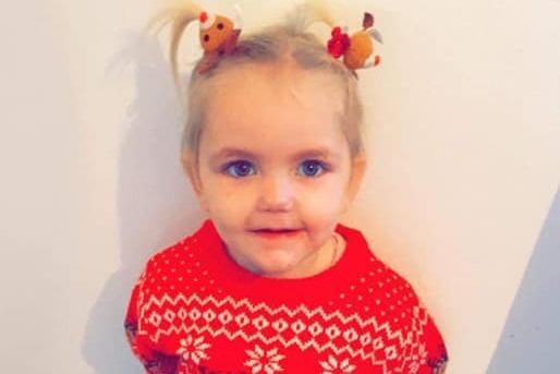 Daisy, age 2, has some festive bobbles to match her jumper. They look great!