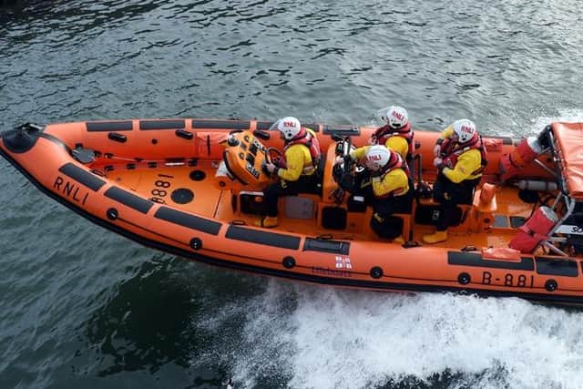 Hartlepool RNLI crew members set off to rescue two men after their kayak capsized.