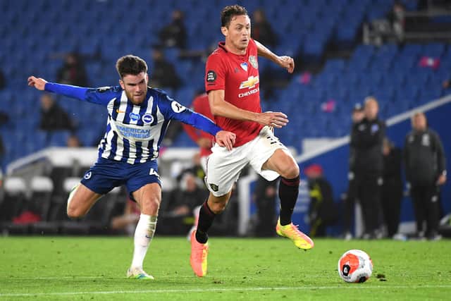 Nemanja Matic of Manchester United holds off Aaron Connelly of Brighton