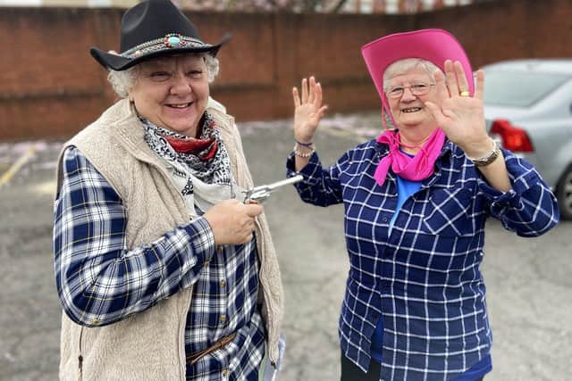 Pauline McSweenie arrests Winnie Atkinson as they wait for their coach to Hartlepool United's last game of the season at Stockport County. Picture by FRANK REID