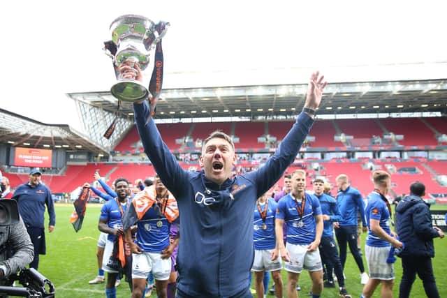 Hartlepool United manager Dave Challinor celebrates with the trophy after winning the shoot-out and promotion after the Vanarama National League play-off final at Ashton Gate, Bristol.