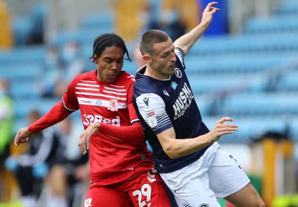 Djed Spence challenges for possession against Millwall.