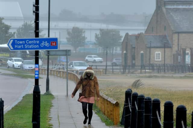 File picture: A pedestrian makes her way against strong winds and rain at Hartlepool Marina. Picture by FRANK REID