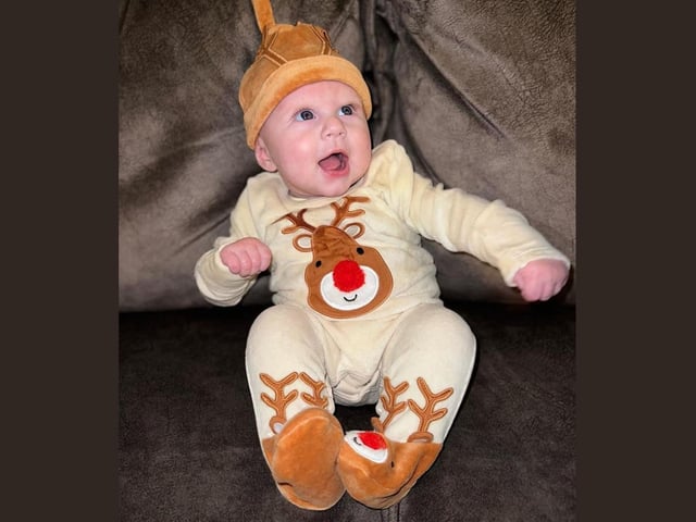 Nellie, age 4 months. We love the reindeer outfit, Nellie!