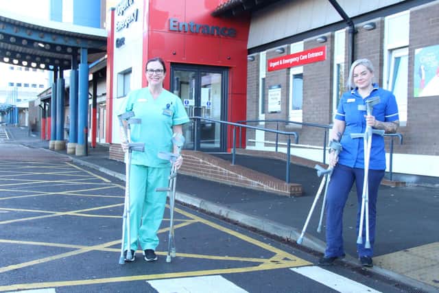 Healthcare assistant Lynn Morris (left) and nurse Sam Cowley with crutches