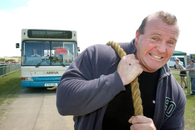 Xtreme Fitness owner Eddy Ellwood pulling a bus during his strongman days.