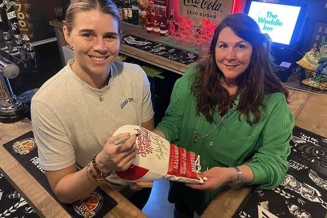 Savannah Marshall presents a signed glove to the owner of the Waddle Inn, Jackie Obeirne, at the opening of the new sports bar in Seaton Carew.