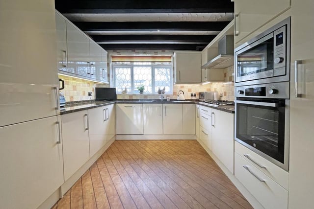 The kitchen blends modern and period features and has multiple appliances.