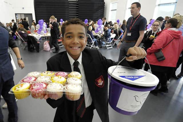 Yea 7 pupil Elliott Robinson (11) offering cakes for a donation during the coffee morning. Picture by FRANK REID