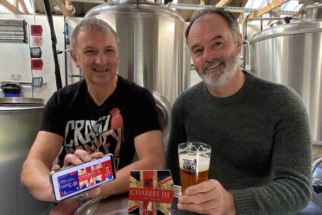 From left, Gary Olvanhill and Pat Garrett with a glass of their new Charles III ale.