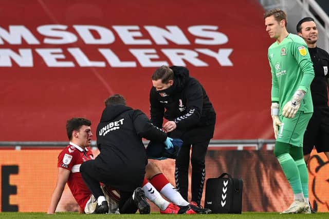Dael Fry receives medical treatment during Middlesbrough's match against Blackburn.