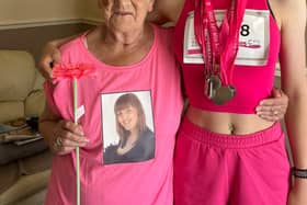 14-year-old Lottie Taylor-Watson stands next to 85-year-old Margaret Wilson after completing her tenth Race for Life.