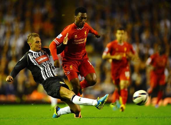 Gary Liddle of Notts County battles with Daniel Sturridge of Liverpool during the Capital One Cup Second Round between Liverpool and Notts County at Anfield on August 27, 2013 in Liverpool, England.  (Photo by Laurence Griffiths/Getty Images)