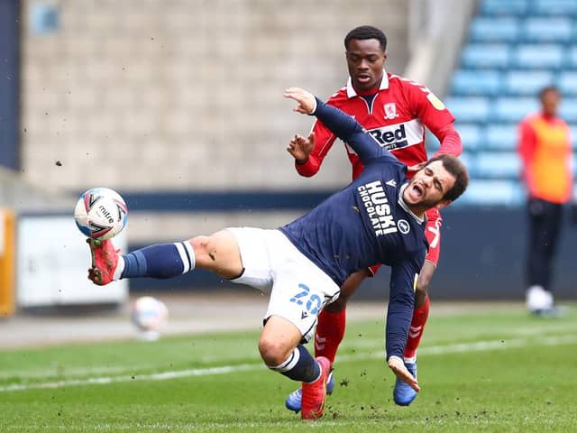 Mason Bennett of Millwall battles for possession with Marc Bola of Middlesbrough.