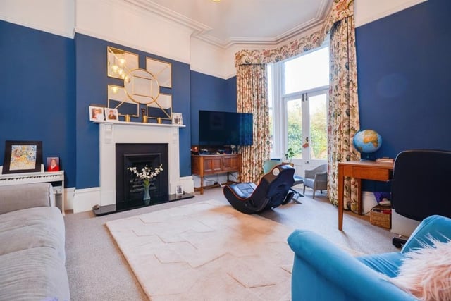 The rear reception room boasts a fireplace and French doors leading to the garden.