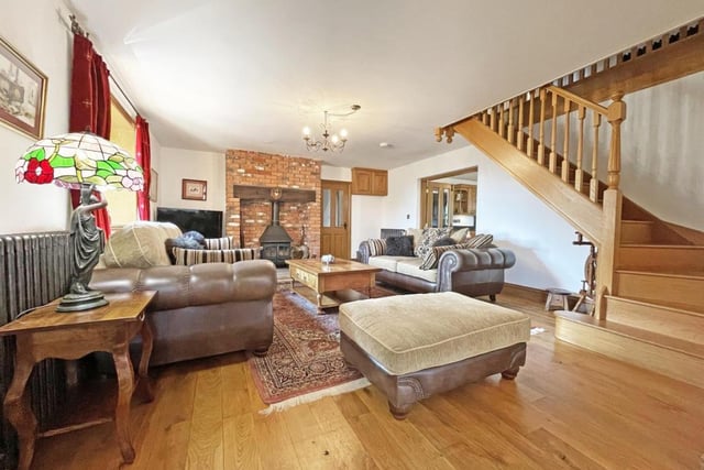 The main living room of Three Gates Farm impresses with its fireplace.