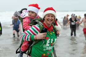 Mum Liz Metcalf with her daughter Harper taking part in last year's Hartlepool Round Table Boxing Day dip at Seaton Carew. Picture by FRANK REID