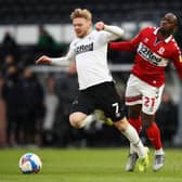 Kamil Jozwiak of Derby County is challenged by Neeskens Kebano of Middlesbrough.