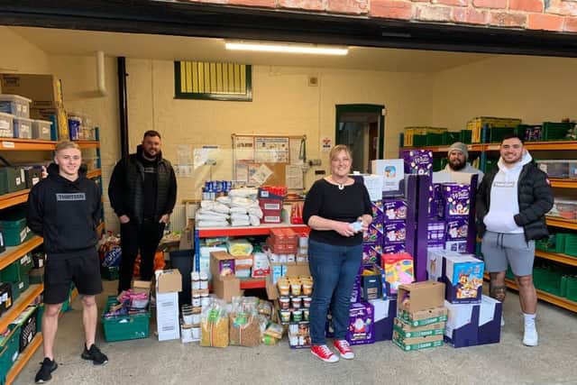 Hartlepool Foodbank coordinator Lisa Lavender receiving a large donation from with Apparel FC manager Jonathon Bull (second from left) and other players bought with money raised by Hartlepool Sunday League in October.