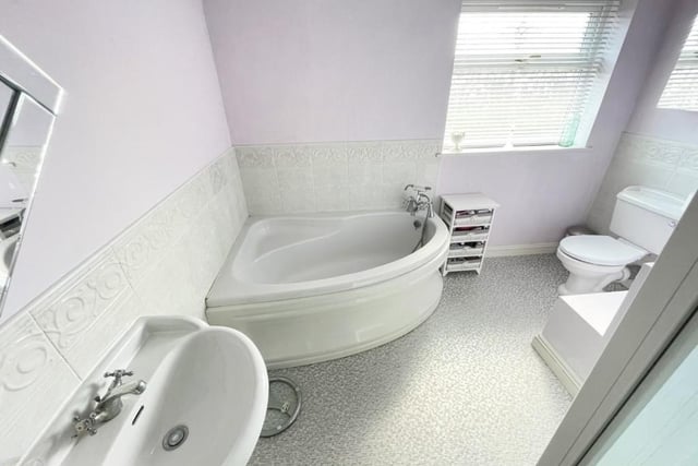 The family bathroom offers a corner bath and a separate shower cubicle.