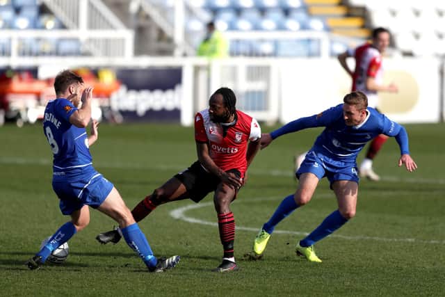 Gary Liddle and Nicky Featherstone of Hartlepool United and Niko Muir of Woking during the Vanarama National League match between Hartlepool United and Woking at Victoria Park, Hartlepool on Saturday 20th March 2021. (Credit: Chris Booth | MI News)