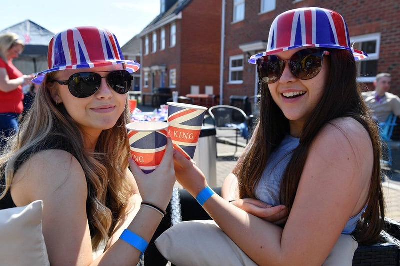 Ella Lakey and Lillie Ball enjoying a refreshing drink during the celebration of King Charles III's coronation at Brian Honour Avenue.