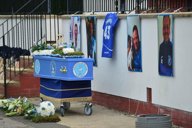 The coffin surrounded by tributes