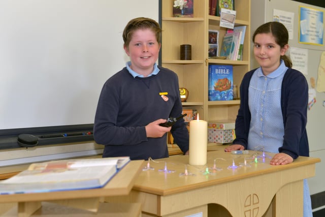 James Corrigan and Charlotte Lawson light a candle at the alter in the school hall in 2015.