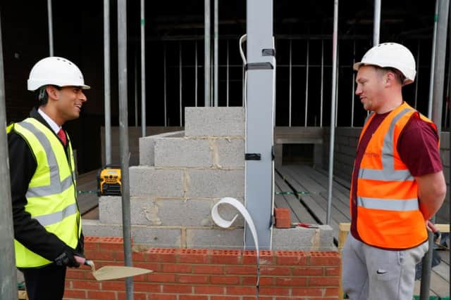 Chancellor of the Exchequer Rishi Sunak talks to bricklayer Danny Honeyman at a construction area during a visit to the Northern School of Art in Hartlepool.