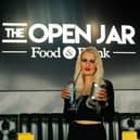 The Open Jar is offering free cocktails to customers who donate a tin of food. Pictured: Staff member Sophie Rogers.