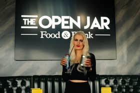 The Open Jar is offering free cocktails to customers who donate a tin of food. Pictured: Staff member Sophie Rogers.