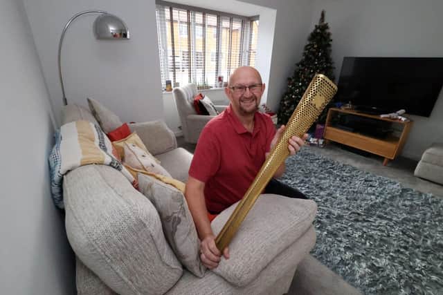Colin Renshaw with his 2012 Olympic Torch, which takes pride of place in the lounge of his new Wingate home.